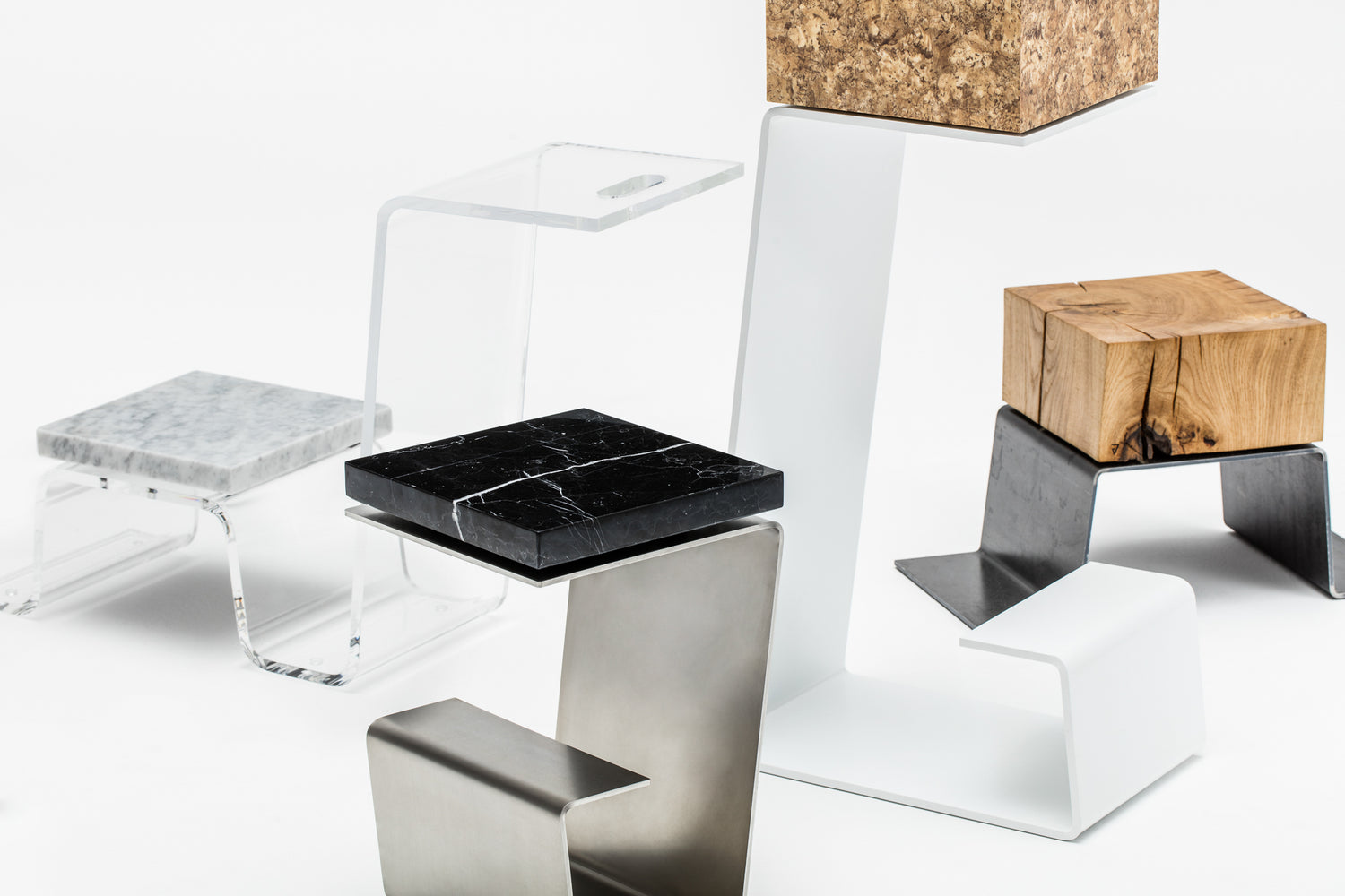 Modern side table, contemporary bar stool, minimalist foot stool and highend coffee table by Baker Street Boys, made of marble, oak, steel and perespex.