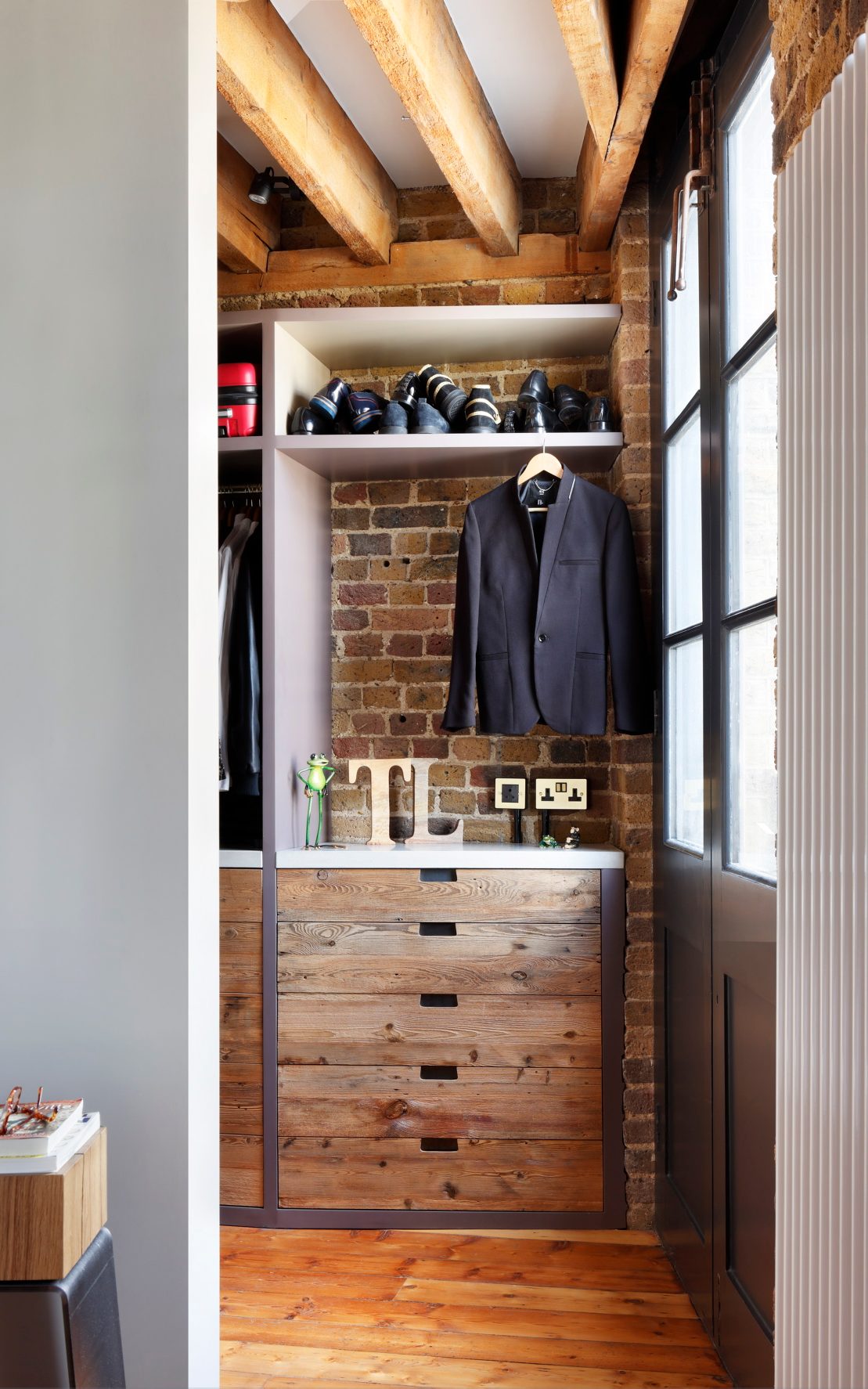 Walk-in closet in Tom Daley’s loft apartment with THE LINE bar stool subtly integrated into the space.