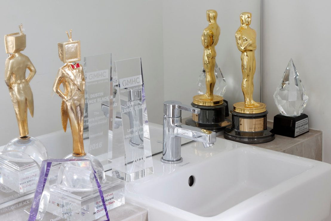 Oscar and other awards displayed in the bathroom of Tom Daley and Dustin Lance Black’s modern London loft.