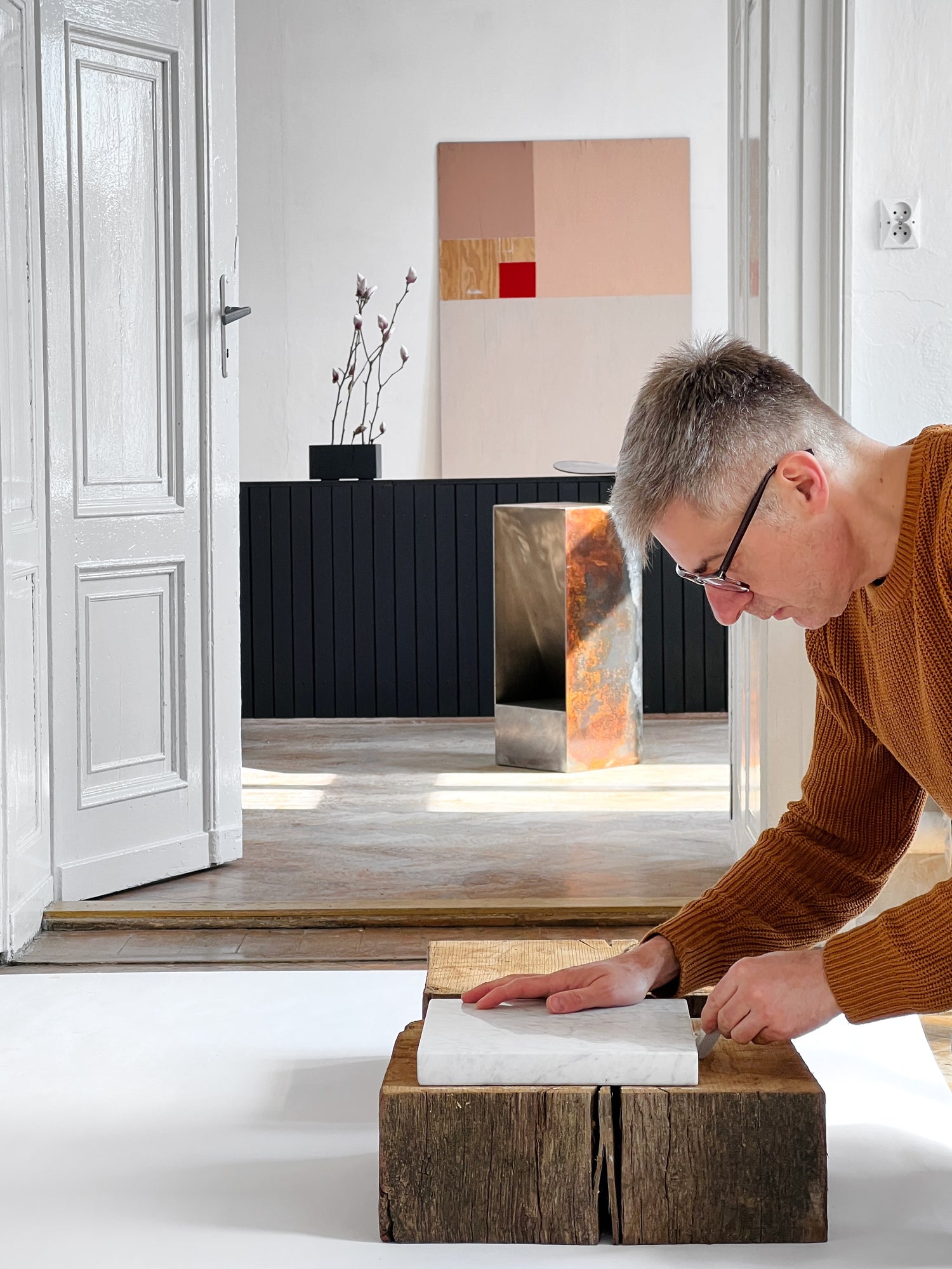 Product designer Tomasz Danielec mesuring oak inside luxury palace interior