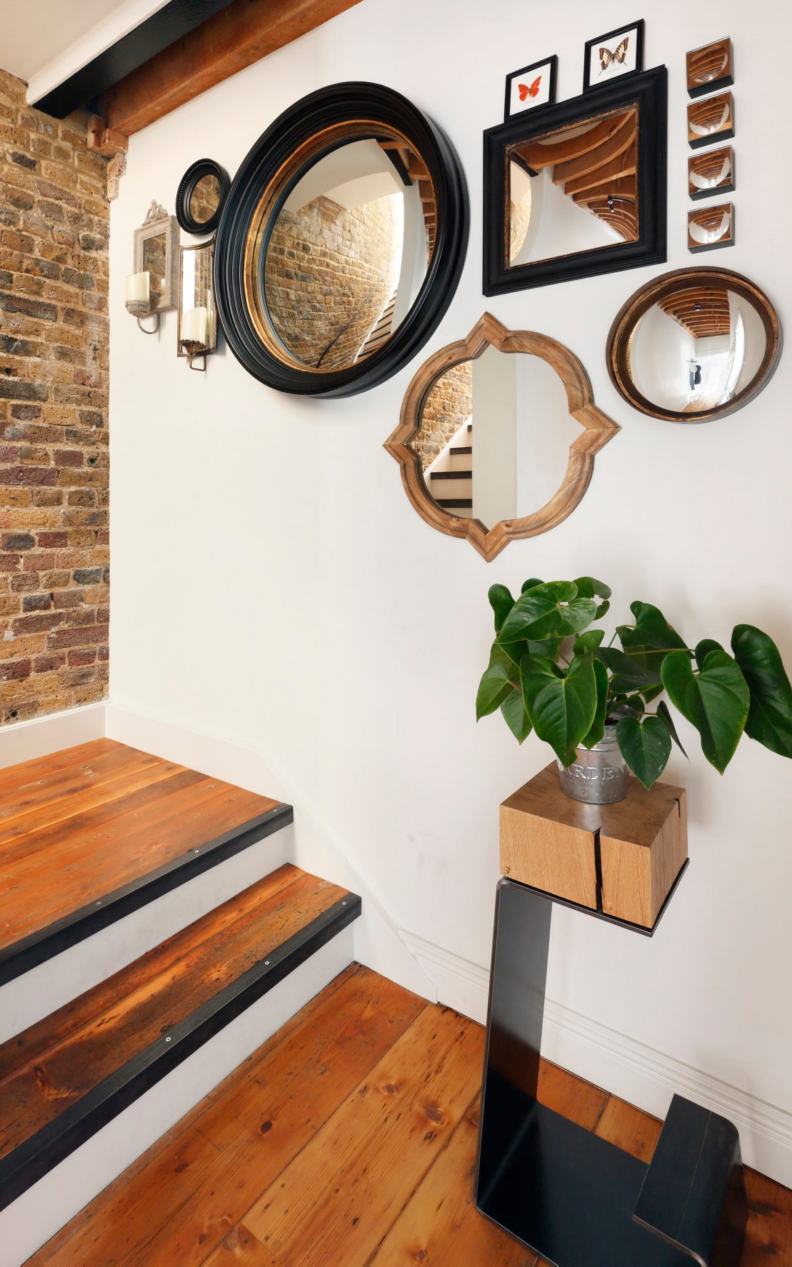 THE LINE bar stool with a potted flower placed on top, positioned in the staircase landing of Tom Daley’s modern London loft.