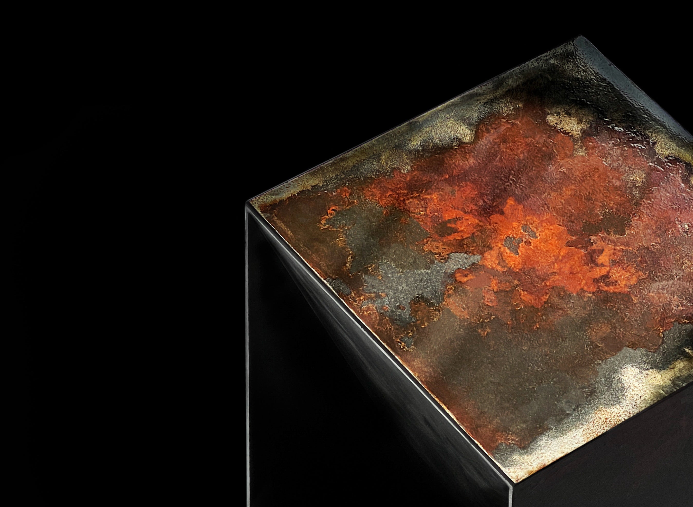 Top of THE BOX bar stool illuminated against black background, showing oxidized steel surface with rust patterns resembling a cosmic texture.